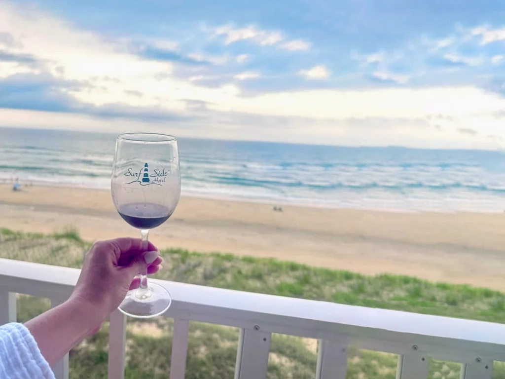 wineglass with surfside logo, beach in distance